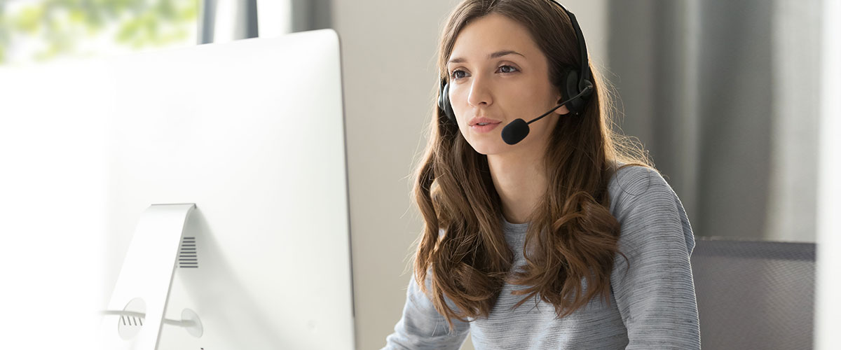 Female doctor working on medical expertise while sitting at desk in front of laptop.